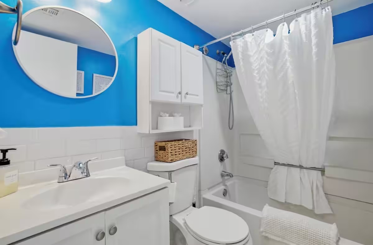 Full bathroom with tub, shower and vanity in the oceanfront studio